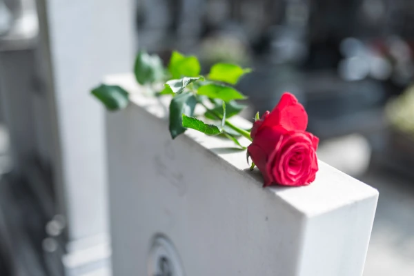 Image of a flower placed on top of a tombstone signifying wrongful death claims
