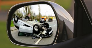 An image of a car accident in the rearview mirror begging the question how are damages calculated