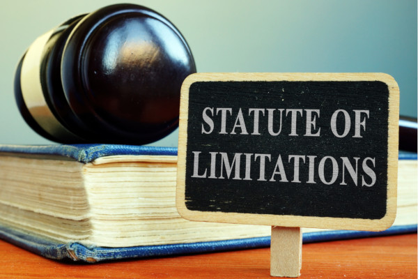 An image of a gavel and a sign reading statute of limitations