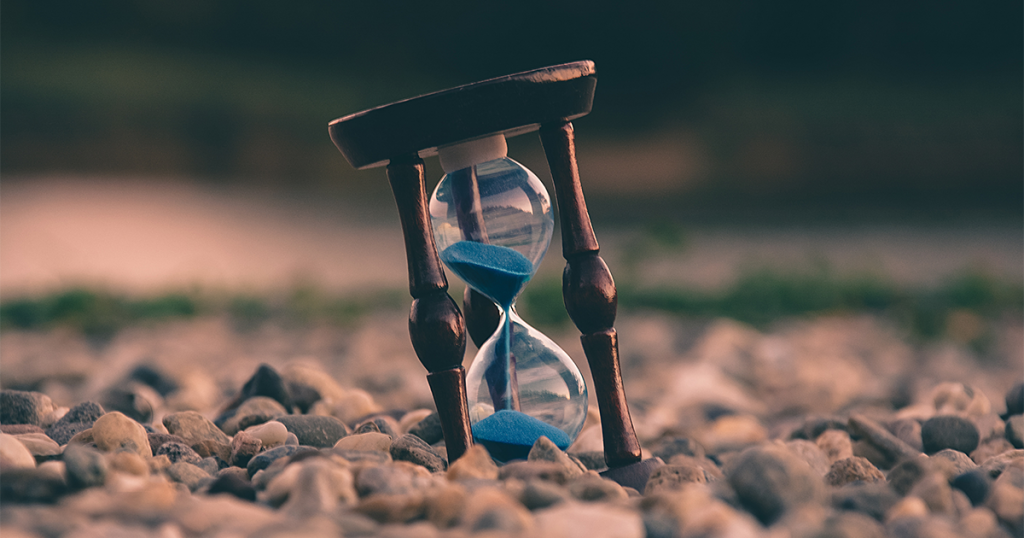 An hourglass with sand falling through, indicating the passing of time.